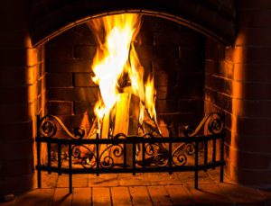 Home fireplace with large wood fire in it Home fireplace with large wood fire in it